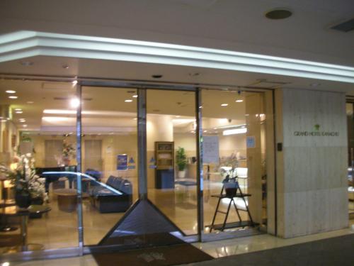 a glass door in a building with a camera at Grand Hotel Kanachu Hadano in Hadano