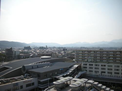 a view of a city with buildings and mountains at Grand Hotel Kanachu Hadano in Hadano