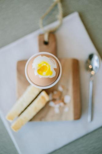 a cup of coffee with an egg on a tray at NUMA HOTEL in Numana