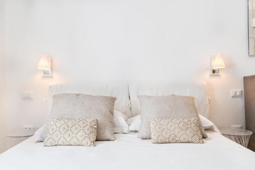 a bedroom with a white bed with two pillows at Cinque Terre Bridge in La Spezia