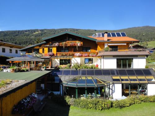 an aerial view of a house with solar panels on it at Wellnesshaus Reichelt in Radstadt