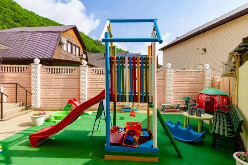 a playground with a slide and a swing set at Guest House Admiral in Nebug