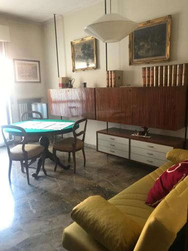 a living room with a table and a couch at Alloggio Galli in Cremona