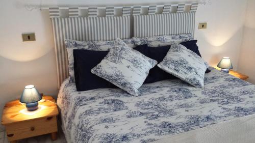 a bedroom with a bed with blue and white sheets and pillows at Verona Amazing River View in Verona