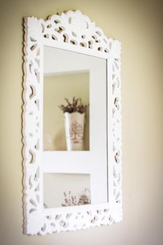a white mirror with a vase on a shelf at Avto Spa in Khmelʼnytsʼkyy