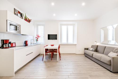 a kitchen and living room with a couch and a table at Cinque Terre Bridge in La Spezia