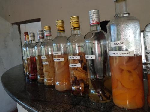a group of bottles of alcohol sitting on a counter at Ecole Lodge Antananarivo in Mahitsy