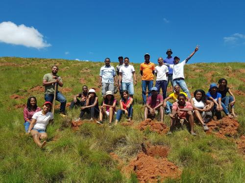 a group of people posing for a picture on a hill at Ecole Lodge Antananarivo in Mahitsy