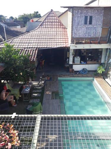 an overhead view of a swimming pool next to a building at Arjuna Garden Homestay in Yogyakarta