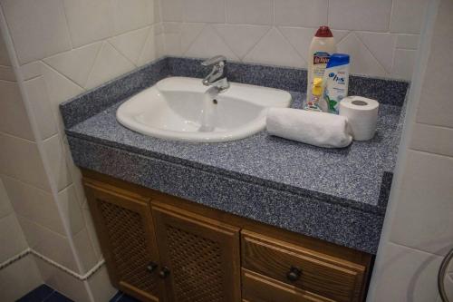 a bathroom counter with a sink and a towel at Martin Gamero Apartments in Toledo