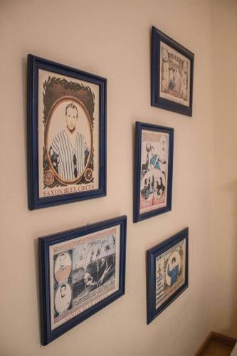 a group of framed pictures on a wall at Martin Gamero Apartments in Toledo