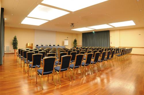 a room with rows of chairs in a hall at Best Western Hotel Globus City in Forlì