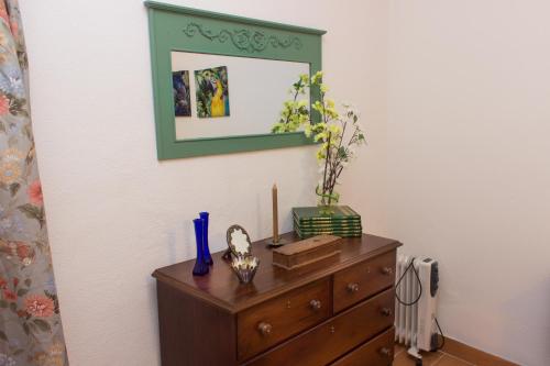 a dresser with a mirror on top of it at Casa dos Tios Estremoz-veiros in Veiros
