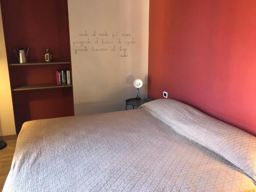a bedroom with a bed and a wall with writing on the wall at Casa Diverio in Stresa