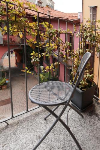 a chair sitting in front of a balcony at Ca' De' Mumi in Luino