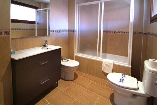 a bathroom with a sink and a toilet and a shower at Apartahotel La Corrala in San Martín de Moncayo