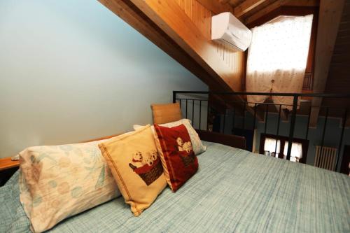 a bedroom with a bed with two pillows on it at Ca' De' Mumi in Luino