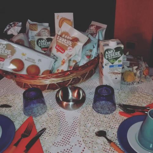 a table topped with a basket of food and snacks at B&B Villa Anita in Bellano