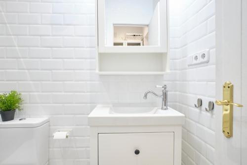 a white bathroom with a sink and a toilet at Your BEST EXPERIENCE in old Madrid - Sol in Madrid