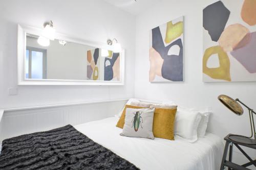 a white room with a bed and a mirror at Your BEST EXPERIENCE in old Madrid - Sol in Madrid