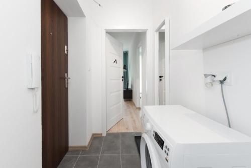 a white laundry room with a washer and dryer at SuperApart Gagarina MiniStudio in Warsaw