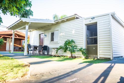 a white house with a porch and a patio at Etzel Tami Hospitality in Neot Golan