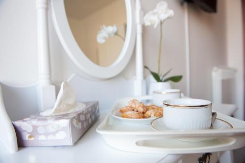 a table with a plate of food and a cup of coffee at B&B CA DEL SOLE in Serravalle Scrivia