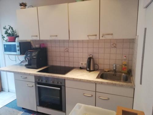 a kitchen with a sink and a microwave at Haus Georg in Innsbruck