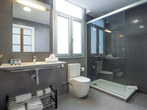 a bathroom with a toilet and a sink and a shower at Rent Top Apartments Rambla Catalunya in Barcelona