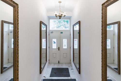 a hallway with mirrors in a house at Romantic designer apartment Prague in Prague