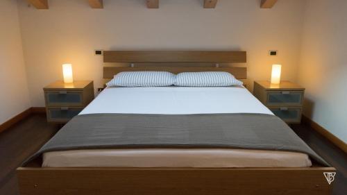 a bedroom with a bed with two night stands at Antico Alveo in Camponogara