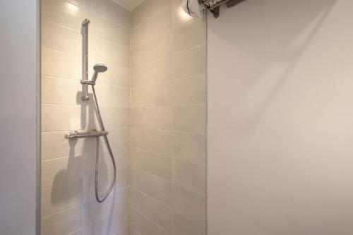 a shower with a shower head in a bathroom at PURA VIDA # meublé plein de charme océan montagne in Villefranque