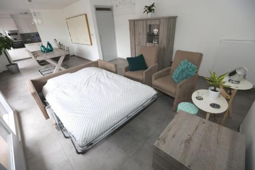 a living room with a large bed and a couch at Windekind V1 in Blankenberge