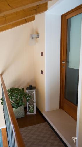 a stairway with a door and a potted plant at Antico Alveo in Camponogara