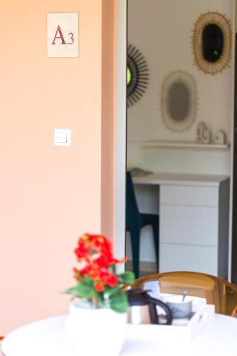 a table with a vase with a flower on it at Chris House in Loutra