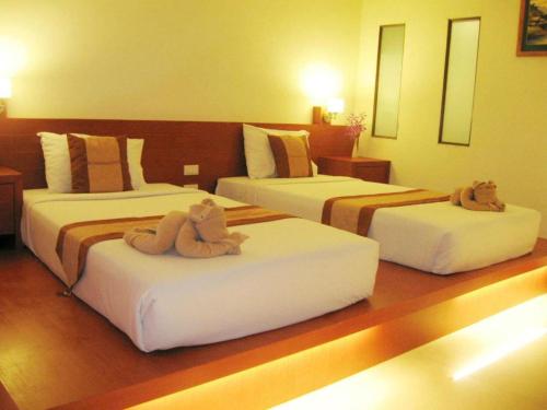 Ένα ή περισσότερα κρεβάτια σε δωμάτιο στο Tanawit Hotel & Spa