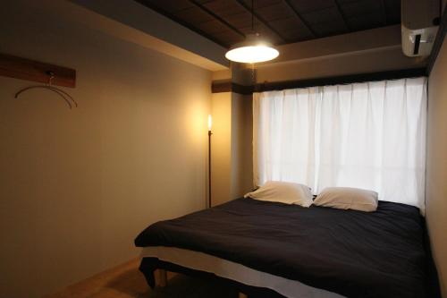 Ένα ή περισσότερα κρεβάτια σε δωμάτιο στο Beppu hostel&cafe ourschestra