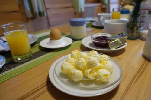 a table with a plate of pasta and an egg at Pension Haus Romy in Schoppernau