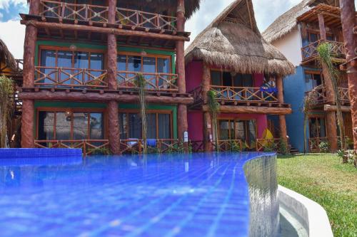 a house with a swimming pool in front of it at Soho Boutique Holbox - Adults Only in Holbox Island