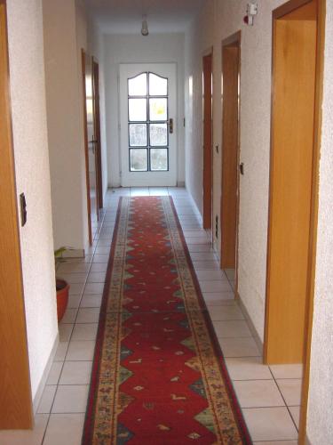 an empty hallway with a rug on the floor at Landgasthof Schuck in Idar-Oberstein