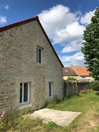 an old stone house with two windows at Gite Bord de Mer 80 m2 in Bernières-sur-Mer