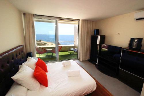 a hotel room with a bed with a view of the ocean at VILA TABARCA QUALITY & LUXURY in Tabarca