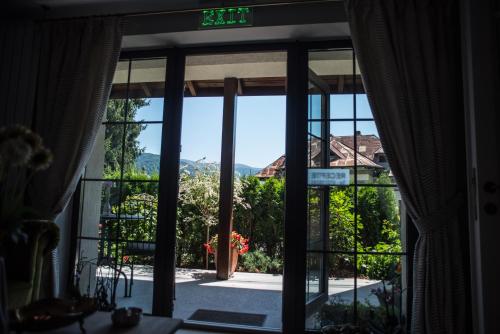 an open door with a view of a yard at Uphill Residence in Sinaia