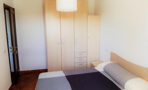 Katil atau katil-katil dalam bilik di Casa vacanza Porto Pino