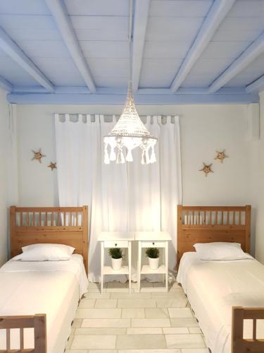 Postel nebo postele na pokoji v ubytování Mare Mare Mykonos