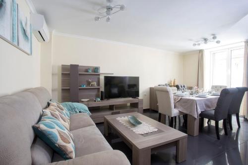 a living room with a couch and a table at Antonella Home Funchal in Funchal