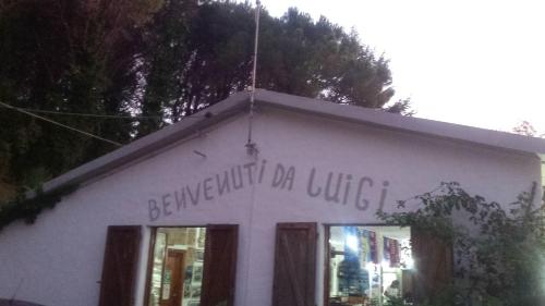 a white building with writing on the side of it at La Casalina dell'Elba in Marciana