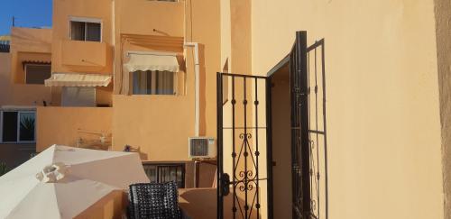 an open door to a balcony with an umbrella at Cozy rooms in terraced house in Fuengirola