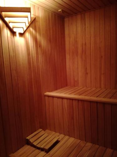 a small wooden sauna with a bench in it at Establecimiento Rural El Chañar in San Rafael