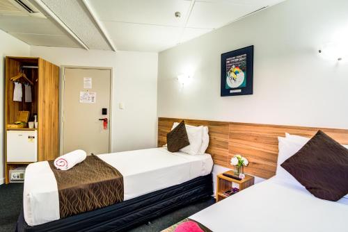 a hotel room with two beds in a room at Ascotia Off Queen in Auckland